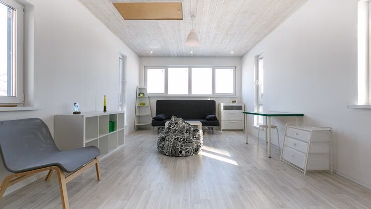 Auf dem Bild ist ein Raum mit einer modernisierten neu angestrichenen Holzdecke abgebildet.