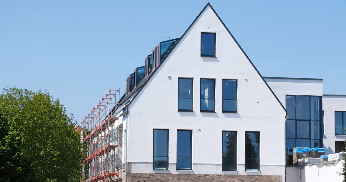 An einem Neubau ist ein Baugerüst aufgebaut.
